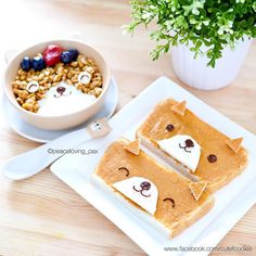 a white plate topped with peanut butter and jelly bear crackers next to a bowl of cereal