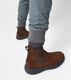 Characterized by a chunky but at the same time sober and refined outsole, the Tod's W. G. style is here proposed in Chelsea boot version. Crafted in velvety suede, with iconic rubber pebbles on the bottom and heel, they are enhanced by Tod's monogram stamped on the front. Casual Chelsea Boots In Calf Leather With Plain Toe, Modern Ankle-high Boots With Textured Sole, Casual Chelsea Boots With Rubber Heel Cap For Work, Casual Workwear Chelsea Boots With Rubber Heel Cap, Modern High-top Chelsea Boots With Lug Sole, Urban Boots With Textured Sole And Round Toe, Ankle-high Boots With Contrast Sole For Walking, Casual Calf Leather Boots With Textured Sole, Casual Workwear Chelsea Boots In Calf Leather