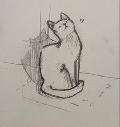 a drawing of a cat sitting on top of a table next to a heart shaped object