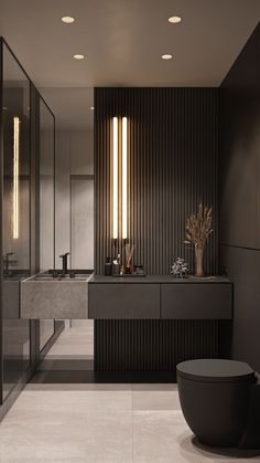 a modern bathroom with black and white walls, flooring and lights on the ceiling