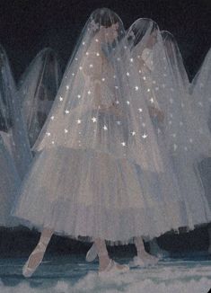 a group of women in white dresses and veils walking down a runway at night