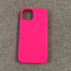 a bright pink iphone case laying on the floor