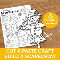 the cut and pastee craft build a scarecrow is shown on a wooden table