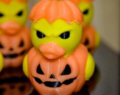 several rubber ducks with pumpkin faces on them