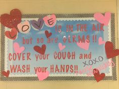 a bulletin board with hearts and words written in pink, red, and blue on it