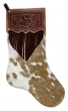 a brown and white cowhide stocking with fringes