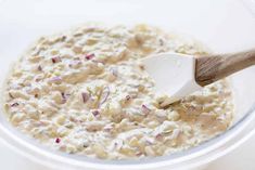 a bowl filled with oatmeal and a wooden spoon