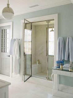 a bathroom with blue walls and white fixtures