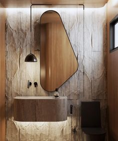 a bathroom with a sink, mirror and toilet in the corner next to a stone wall