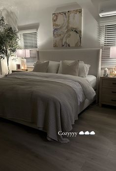 a large bed sitting in a bedroom next to two lamps