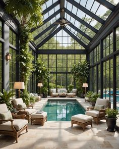 an indoor swimming pool surrounded by plants and furniture in the middle of a room with large windows