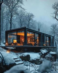 a small cabin in the middle of a snowy forest with rocks and trees around it