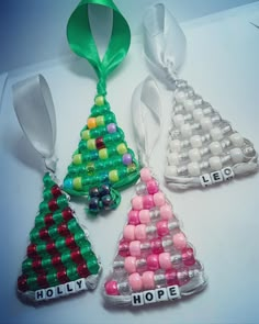 three christmas tree ornaments with the word hope spelled on one ornament in different colors