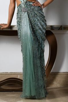 Sea green and blue sleeveless draped gown with all over astral bloom embroidery using tonal crystals, beads, sequins, pearls, cutdana highlights, side cutout, criss cross back and cutwork borders detail. - Aza Fashions Embellished Draped Gown For Reception, Pre-draped Embellished Gown For Reception, Sleeveless Green Gown For Reception, Green Hand Embellished Gown For Reception, Green Sequined Reception Gown, Green Sequined Gown For Reception, Green Embellished Pre-draped Saree For Reception, Embellished Green Pre-draped Saree For Reception, Green Hand Embellished Floor-length Gown