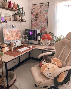 a chair with a stuffed animal on it in front of a computer desk