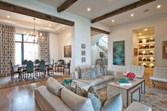 a living room filled with furniture and lots of windows