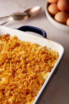 a casserole dish with eggs in the background