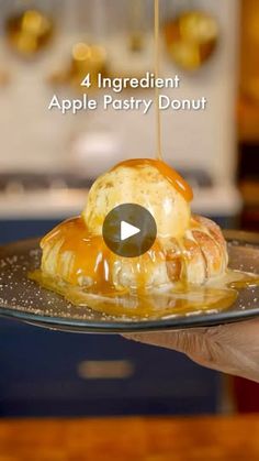 a person is holding a plate with some food on it and the words, 4 ingredient apple pastry donut