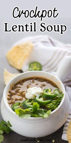 a white bowl filled with soup next to tortilla chips