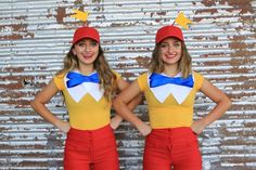 two women in costumes standing next to each other with their hands on their hipss