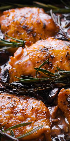 closeup of cooked chicken with rosemary garnishes