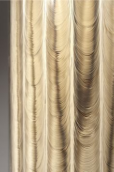 a close up view of a curtain with wavy lines on the outside, and light shining through it