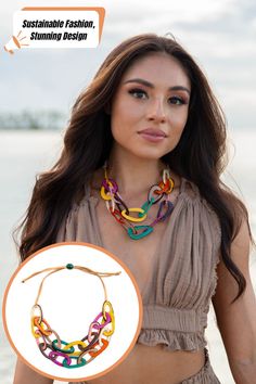 A poised woman wearing a flowing navy dress and accessorized with matching blue drop earrings and a chunky linked necklace. The necklace, shown in a detailed inset, features a blend of navy and cream tones, paired with a sustainable fashion message. Necklace For Everyday, Everyday Chic, Timeless Gifts, Eco Friendly Fashion