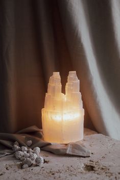 a lit candle sitting on top of a table