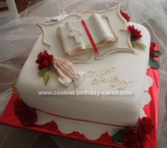 a cake decorated with an open bible and flowers on top of a red table cloth