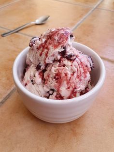 a bowl filled with ice cream sitting on top of a tiled floor