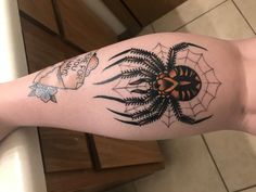 a person with a spider tattoo on their arm