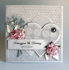 a wedding card with flowers on it and a name tag attached to the front of the card