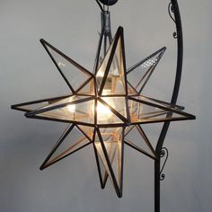 a star shaped light hanging from the ceiling