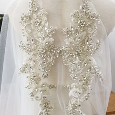 Pure hand beaded sewn silver crystal and rhinestone beaded bodice applique Size for one piece is about 16X44cm Gorgeous for wedding, couture design, bridal gown straps ... Back to rhinestone section https://www.etsy.com/shop/lacetime/items?ref=seller-platform-mcnav&section_id=15471438 my shop link: http://www.etsy.com/shop/lacetime ------------------------------------------------------ ---------------------------------------------------------------- ------------------------------------------ White Crystal Bridal Accessories With Rhinestones, Crystal Bridal Accessories With Rhinestones For Bride, Silver Embellished Wedding Dress, Embellished Silver Wedding Dress, Bodice Applique, Wedding Couture, Couture Design, Rhinestone Appliques, Beaded Bodice