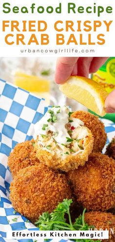 fried crispy crab balls on a blue and white checkered plate with lemon wedges