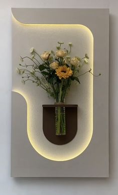 a vase filled with flowers sitting on top of a white wall mounted light paneled in to the side of a wall