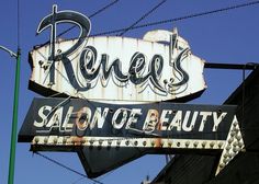 a sign that says roses salon of beauty on it's side with barbed wire