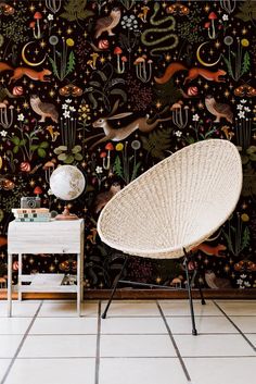 a chair and table in front of a wall with an animal pattern on the wall