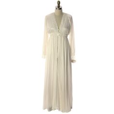 This is one beautiful nylon peignoir ( robe& nightgown) by Miss Elaine in virginal white, new with tags-I just cleaned out a collection of vintage unworn lingerie including Vanity Fair, Miss Alice, Miss Elaine and more- so check back!The sleeveless 100% nylon nightgown has an empire elastic waist with deep lace-trimmed V neck and bow trim. Lace-trimmed Hem. The robe has no lace at the hem but does all the way down the front and all around the neck and cuffs. It has a three covered button clo Open Front White Dress For Daywear, White Open Front Dress For Daywear, White Open Front Daywear Dress, Spring White Robe For Bedtime, White Spring Bedtime Robe, Long Robe With Lace Trim For Daywear, Long Daywear Robe With Lace Trim, White Vintage Robe For Daywear, Vintage White Robe For Daywear