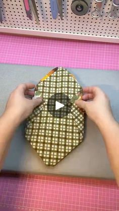 someone is making an ornament out of fabric