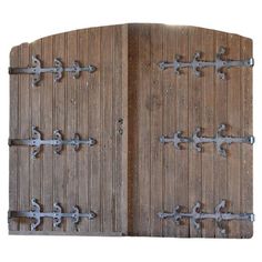 an old wooden door with metal latches on the doors and side panels that are open