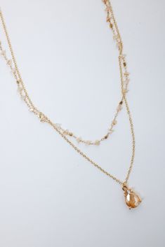 Champagne Crystal Double Necklace Gold Toned Double Chain Necklace Shorter necklace has chunk wired wrapped genuine stones Longer necklace has champagne crystal teardrop 15" in length for shorter necklace 17" in length with 2" extender Lobster claw closure Gold Wire Wrapped Dangle Crystal Necklaces, Gold Crystal Necklace With Natural Stones Dangle, Gold Teardrop Drop Necklace With Natural Stones, Gold Teardrop Pendant Necklace With Wire Wrapped, Gold Double Strand Crystal Necklace With Natural Stones, Gold Teardrop Wire Wrapped Necklace, Gold Wire Wrapped Crystal Necklace, Double Chain Necklace, Double Necklace