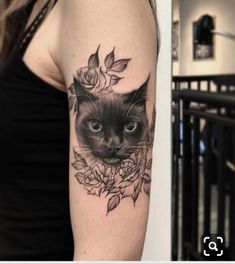 a woman with a cat tattoo on her arm