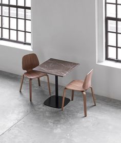 two chairs and a table in an empty room