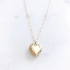 DESCRIPTION: The ELIZABETH Necklace - Gold Heart Locket on a dainty gold filled chain. We love this sweet little necklace and think you will too! Insert a treasured photo and keep it close to your heart! The cutest way to show your love for someone special!MATERIALS:Chain, Clasp, Jump Rings - Gold Filled  Locket - Gold PlatedPENDANT SIZE:Approximately 3/4” in lengthPACKAGING:Your necklace will arrive on a Dainty Doe signature jewelry card placed in a white jewelry box, with a bow and tag, perfec Locket Gold, Silver Jewelry Cleaner, Necklace Locket, Gold Heart Locket, White Jewelry Box, Mothers Day Gifts From Daughter, Heart Locket Necklace, Dainty Gold Necklace, Crescent Moon Necklace