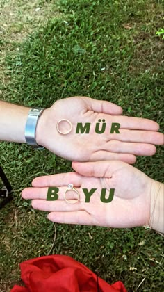 two hands with the words mur and byu written on them