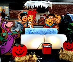 an outdoor display with pumpkins and cartoon characters