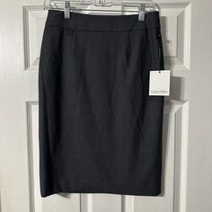 Nwt Calvin Klein Pencil Skirt. Charcoal Gray In Color. Zipper With Hook And Eye Back Closure. Fully Lined. Polyester/Rayon/Spandex Material. Size 2. Chic Calvin Klein Skirt For Workwear, Chic Calvin Klein Skirt For Work, Elegant Calvin Klein Skirt For Work, Calvin Klein Fitted Pencil Skirt, Calvin Klein Fitted Skirt, Fitted Calvin Klein Casual Skirt, Calvin Klein Fitted Casual Skirt, Casual Fitted Calvin Klein Skirt, Hook And Eye