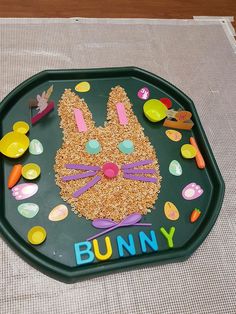 a green plate topped with a bunny made out of cereal