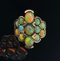 Fantastic new opal ring with 13 beautiful oval cut stones set in blackened, sterling silver with a 18k yellow gold plate. Lots of color play in the gems and they are perfectly matched. A wonderful statement ring with rainbows of color. 11.64g Ring Size 8. Multicolor Oval Cabochon Opal Ring, Unique Multicolor Cabochon Opal Ring, Gold Souk, Color Play, Opal Ring, Multi Stone Ring, Multi Stone, Opal Rings, Stone Settings